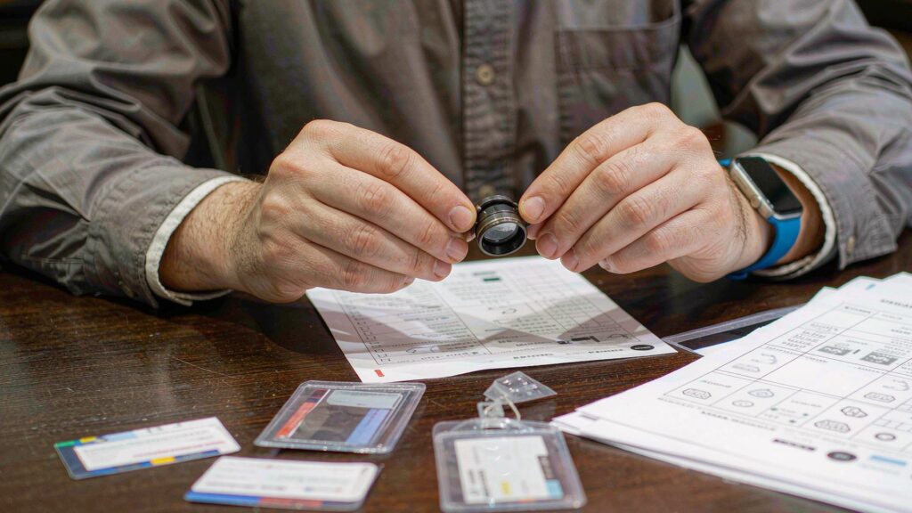 Engineer reviewing a card printing specification and QC checklist